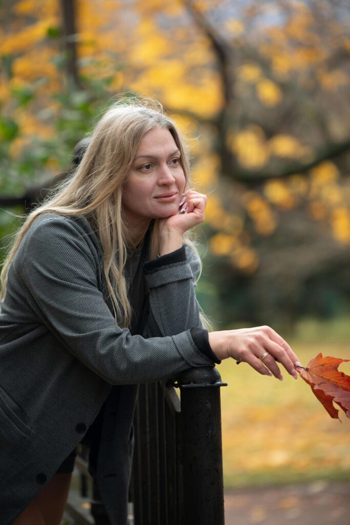 leaf | eating disorder recovery coaching online | British eating disorder recovery coach | England | Ireland | Scotland Smiling woman standing outside holding a leaf. Connect with a British eating disorder recovery coach and explore eating disorder recovery coaching online in England.