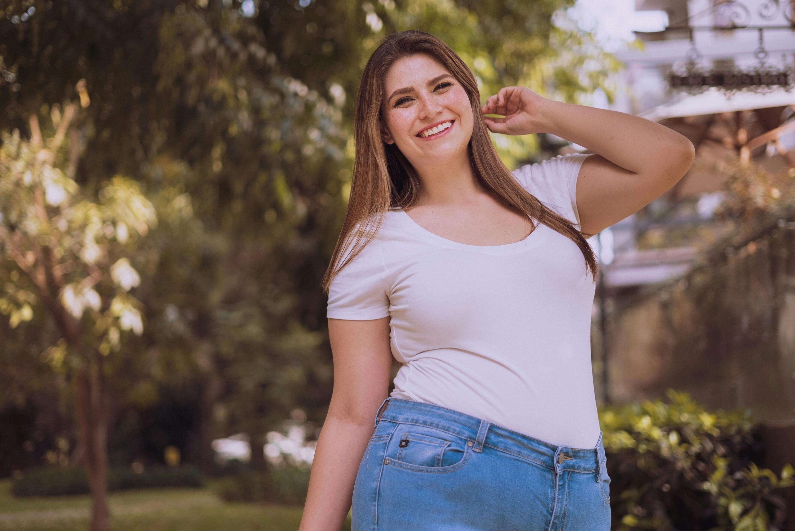 Smiling plus size woman posing while standing outside. With Anorexia Nervosa Recovery in England you can start to heal and manage your anorexia symptoms in healthy ways with support.