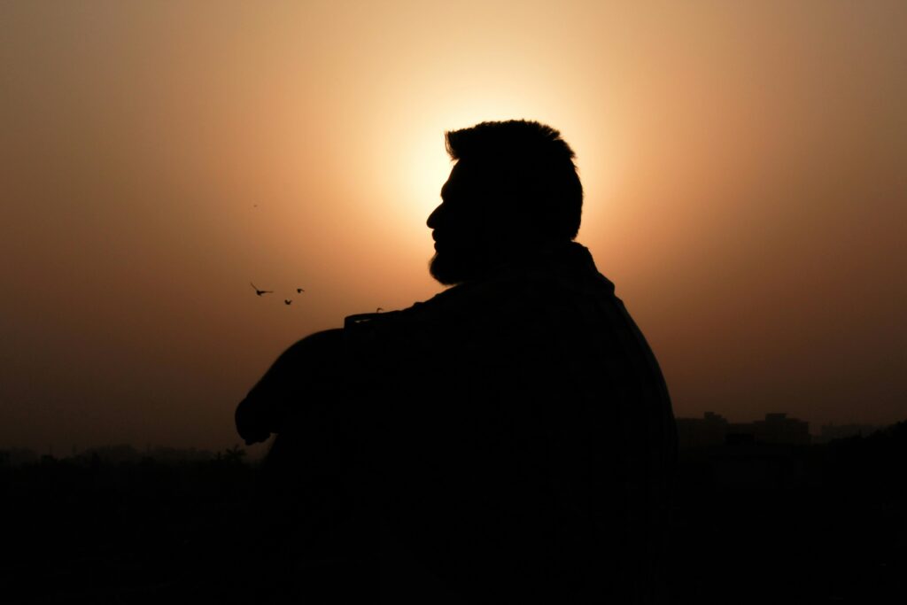 peaceful man | eating disorder recovery coaching | eating disorder recovery coach | England | Scotland | Ireland Silhouette of a peaceful man during sunset. Stay committed to your goals with eating disorder recovery coaching in England and guidance from a trusted eating disorder recovery coach.
