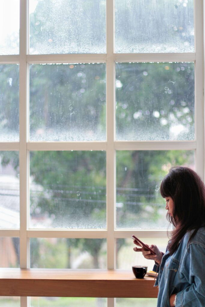 cell phone | eating disorder coaching | eating disorder recovery coaching | England | Ireland | Wales Thoughtful woman holding a cell phone texting. Discover how eating disorder coaching and eating disorder recovery coaching in England can support your accountability and long-term recovery.